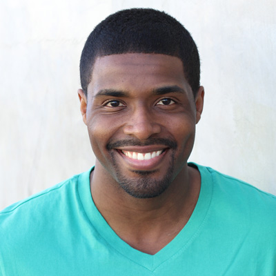 An elderly couple sharing a joyful moment, smiling broadly at the camera.